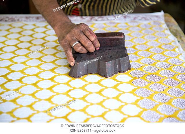 Jaipur, India - Indian man stamping pattern on fabric