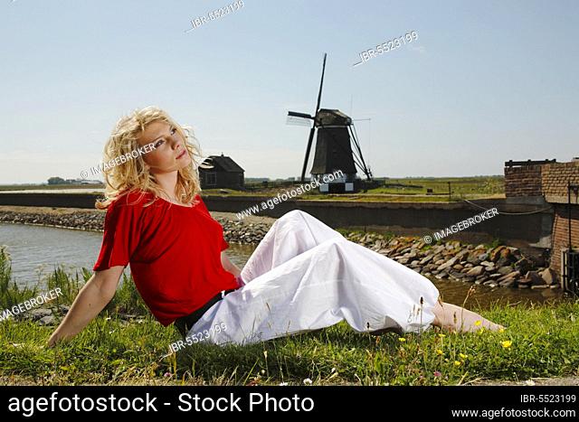 Woman in a meadow, windmill 'De Bol', Het Noorden, Texel, Netherlands