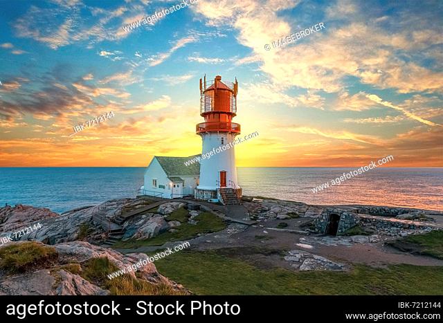 Lighthouse surrounded by rocks at sunset, lighthouse surrounded by rocks near the ocean