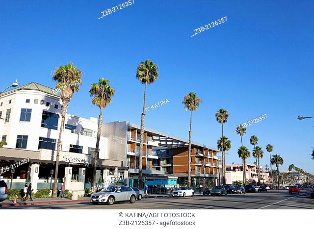 Restaurants, shops and pedestrains along palm tree-lined, trendy Ocean Avenue in Santa Monica, California, USA