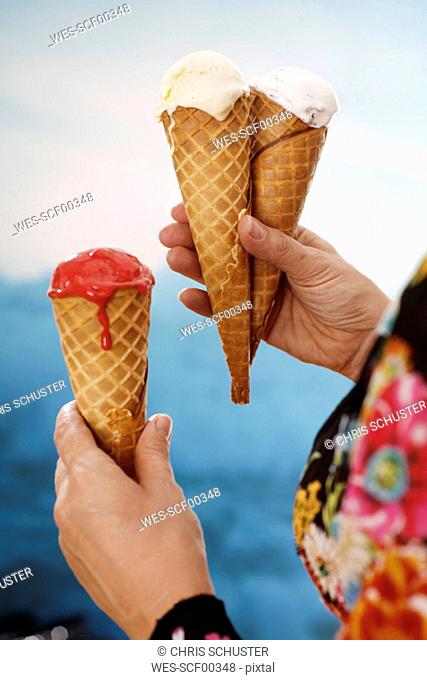 Woman holding ice cream, close-up