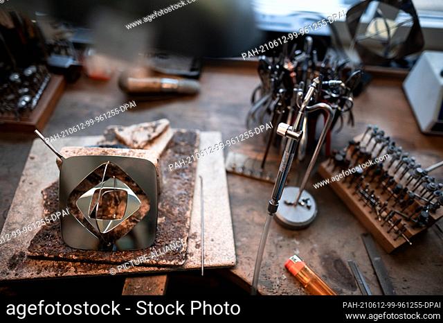 PRODUCTION - 08 June 2021, North Rhine-Westphalia, Marl: An unfinished trophy lies on a worktop. Christiane Kühler makes the Grimme Prize trophies at the...