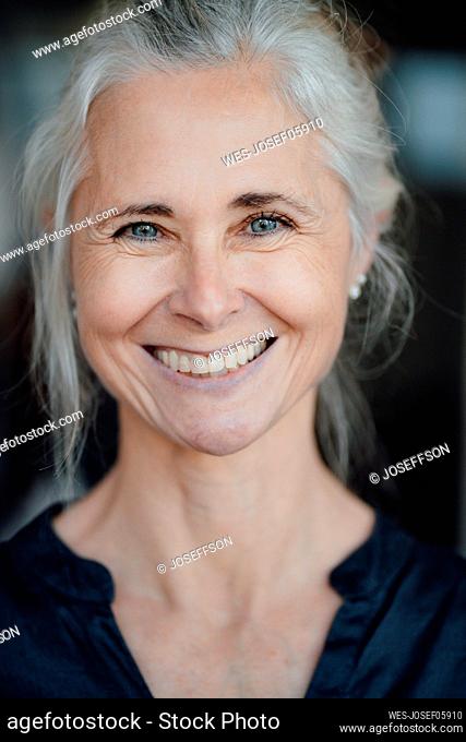 Happy mature woman at coffee shop