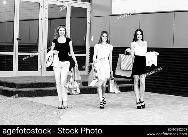 Three young women walking on a summer day in the city