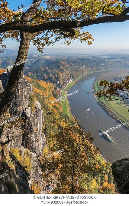 View from the spectacular rock formation Bastei (Bastion) to health resort Rathen and the Elbe River. The Bastei is one of the most visited tourist attractions...