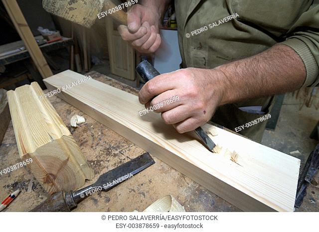 forefront of the hands of a carpenter working