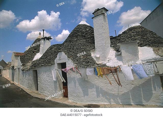 Italy - Apulia Region. Le Murge. Folk architecture at Alberobello (Bari province), Rione Aia Piccola. Conical buildings 'Trulli'