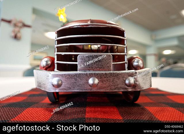 The grill of an old toy pickup truck displayed on a table