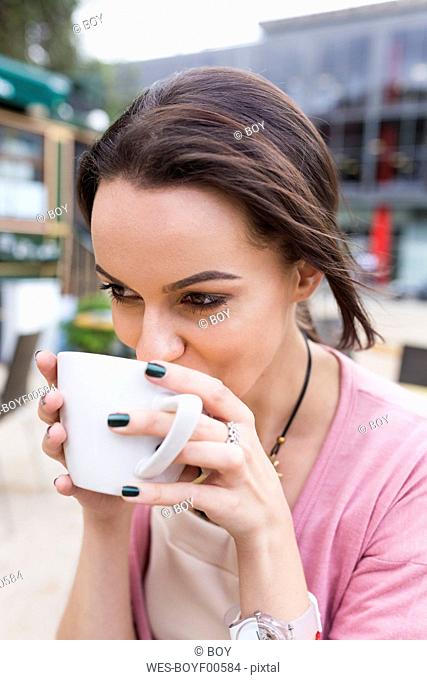 Young woman drinking cappuccino