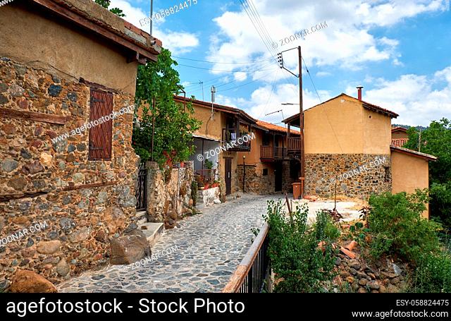 The view of narrow mediaeval street of old Kakopetria surrounded by the traditional houses lined by the stone. Nicosia District. Cyprus