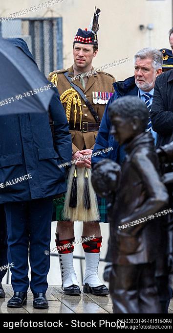 31 March 2023, Hamburg: Lieutenant Colonel Johnny Thompson, Equerry (stable master) of the British King, stands at the monument ""Kindertransport - the last...