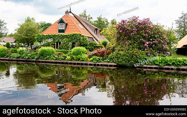 Historic thatched houses along a canal in the beautiful little village Blokzijl in the Netherlands
