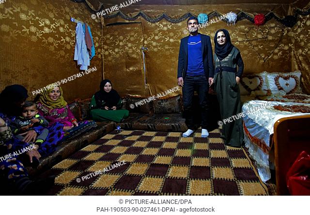 03 May 2019, Lebanon, Anjar: Syrian refugee Nissreine Ali (R), 16, stands beside her husband 22 years old Ibrahim al-Abed as they receive guests at their...