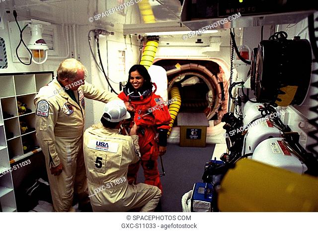 11/19/1997 --- STS-87 Mission Specialist Kalpana Chawla, Ph.D., is assisted with her ascent and re-entry flight suit in the white room at Launch Pad 39B by...