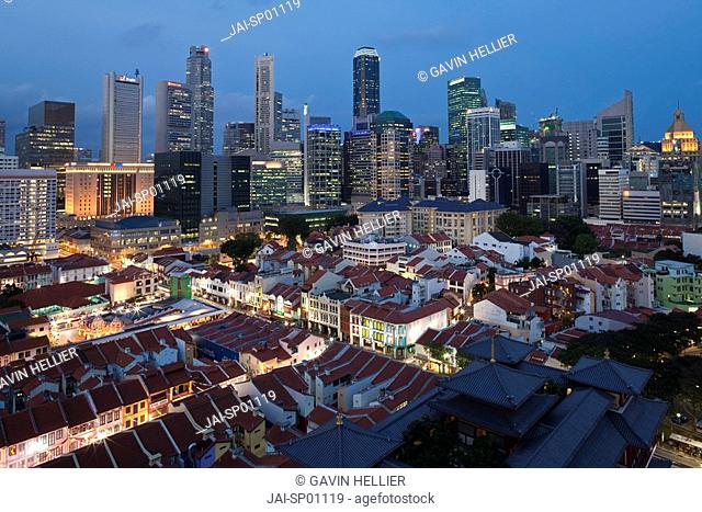 Elevated view over Chinatown, the new Buddha Tooth Relic temple and modern city skyline, illuminated at dusk, Singapore, Asia