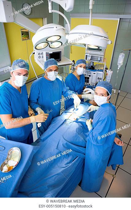 Surgery team looking at camera during operation