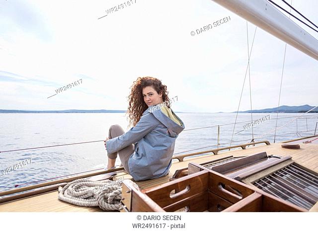 Happy young woman on yacht