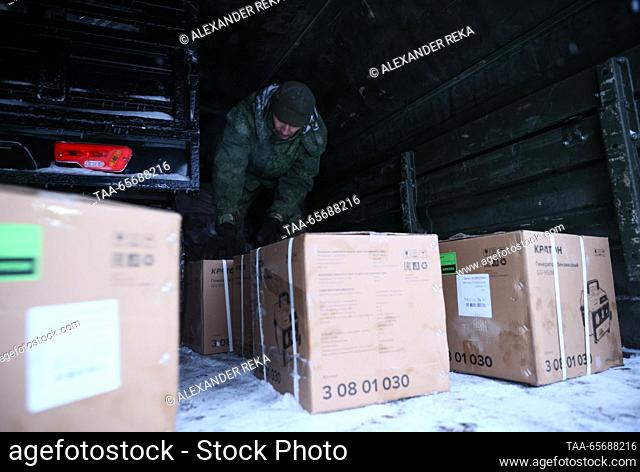 RUSSIA, LUGANSK - DECEMBER 12, 2023: A man helps load the cargo into trucks as SEPAR ZOV volunteers collect more than 20 pieces of special equipment and other...