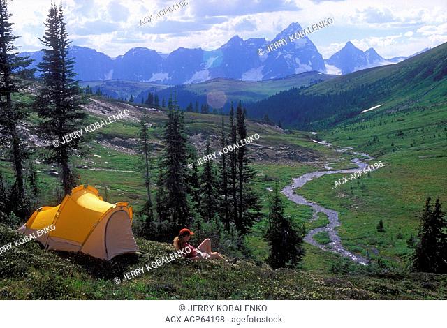 Woman camper overlooking Ptarmigan Valley, Purcell Mountains, British Columbia, Canada