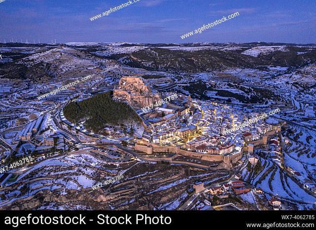 Morella medieval city aerial view, in a winter twilight - blue hour, after a snowfall (Castellón province, Valencian Community, Spain)