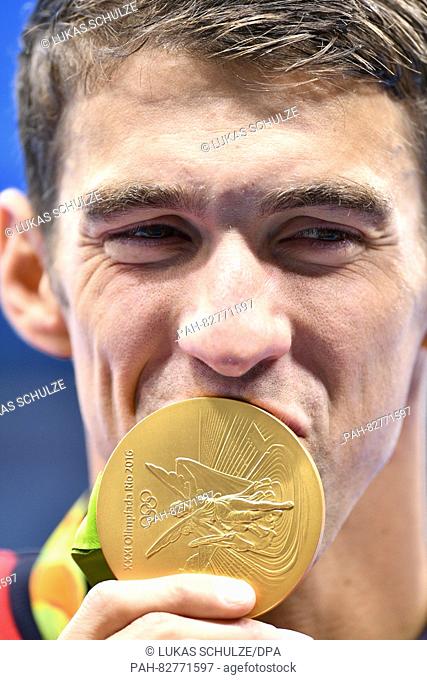 Michael Phelps of the USA kisses his Gold medal after the Men's 4 x 100m Medley Relay Final of the Swimming events of the Rio 2016 Olympic Games at the Olympic...