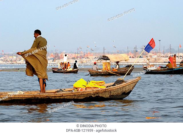 Boats ferry devotees at the confluence of the Ganges , Yamuna the mythical Saraswati rivers to take a holy dip during the Ardh Kumbh Mela , , , India