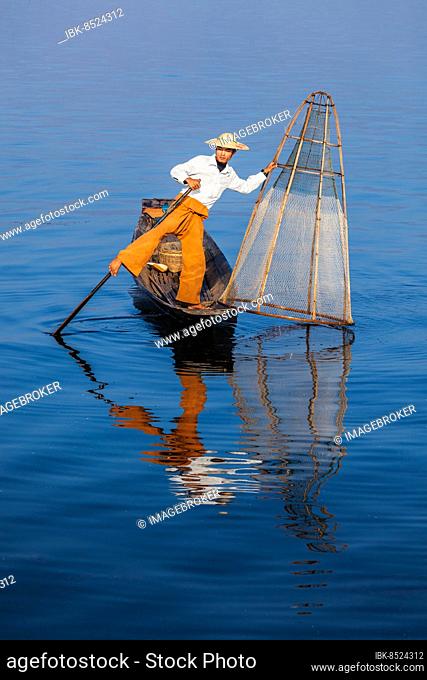 Myanmar travel attraction landmark, Traditional Burmese fisherman at Inle lake, Myanmar famous for their distinctive one legged rowing style