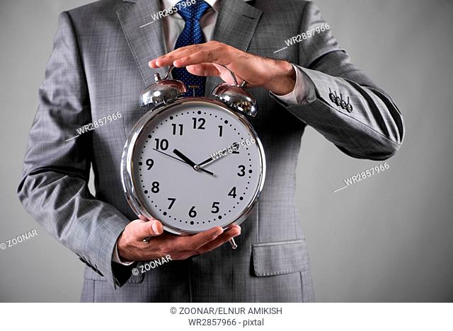 Businessman with clock in business concept