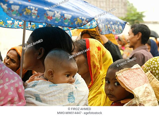 An assemblage of people to buy rice at a fair price shop, run by Bangladesh Rifles, BDR, at Nababganj Park, near Lalbagh, Dhaka Bangladesh April 04, 2008