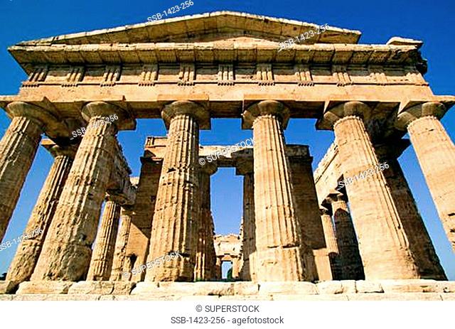 Low angle view of the old ruins of a temple, Temple of Neptune, Paestum, Campania, Italy
