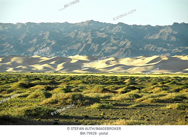 Steppe dunes and mountain range in Gobi Desert Khongoryn Els Gurvan Saikhan National Park Mongolia