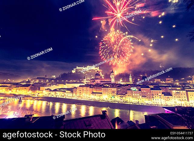 Colorful firework in the night: Old city of Salzburg and Festung Hohensalzburg at New Year?s Eve. Magic