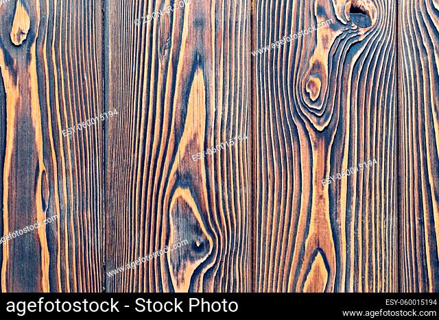 close-up texture larch wood. dark brown countertop or background