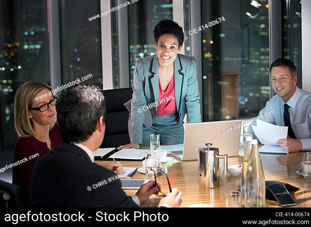 Business people meeting in conference room at night