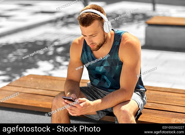 young athlete man with headphones and smartphone