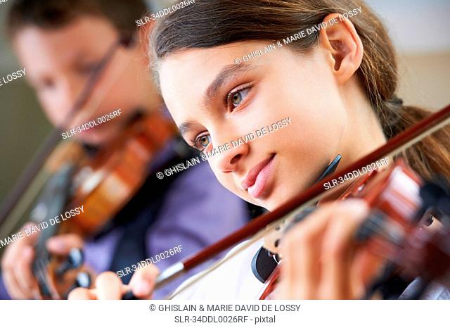 Serious children playing violin