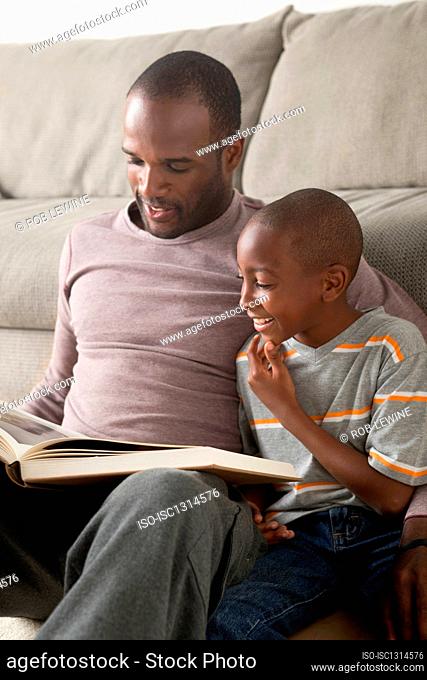 Father and son reading book