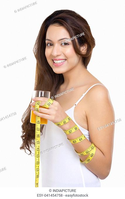 Portrait of woman holding glass of orange juice