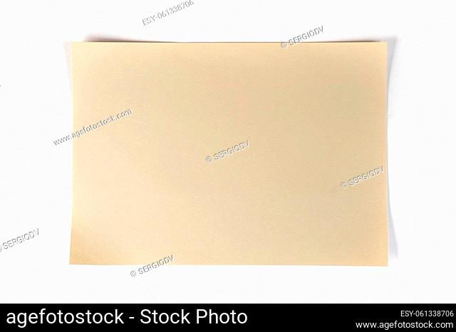 a blank sheet of suede-colored paper on a white surface
