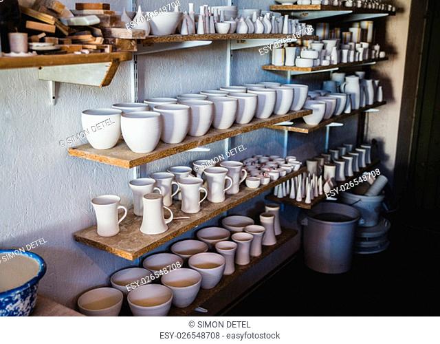 pottery shelf with white ceramics dishes tableware