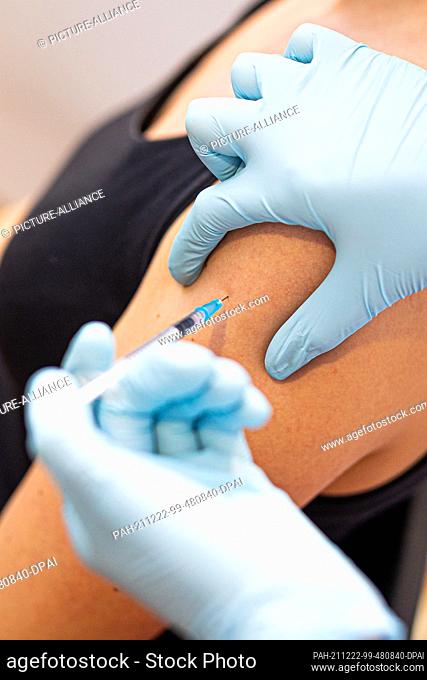 22 December 2021, Lower Saxony, Hanover: A woman gets vaccinated against Covid-19 during a vaccination campaign at the HDI Arena, Hannover 96's stadium