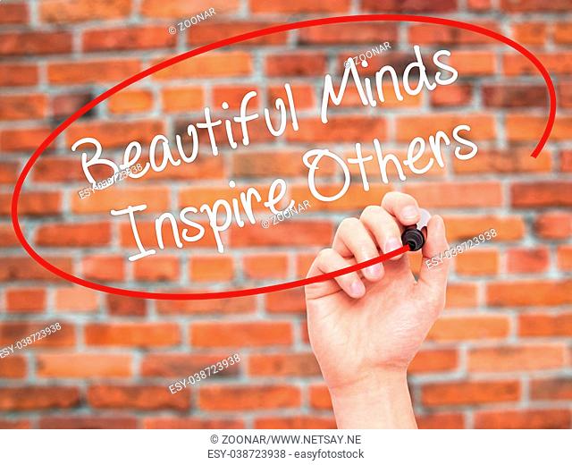 Man Hand writing Beautiful Minds Inspire Others with black marker on visual screen