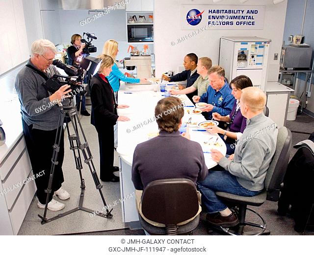 STS-133 crew members participate in a food tasting session in the Habitability and Environmental Factors Office at NASA's Johnson Space Center