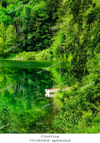 Spring season lonely boat Lokve lake near Mrzla vodica in Croatia