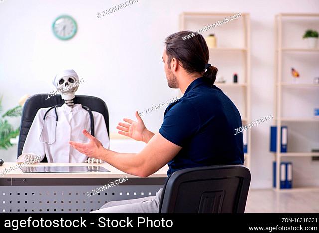 Young man visiting dead doctor in hospital