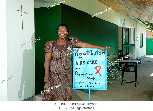 Woman and sign, HIV/AIDS awareness, Gaborone, Botswana, Africa