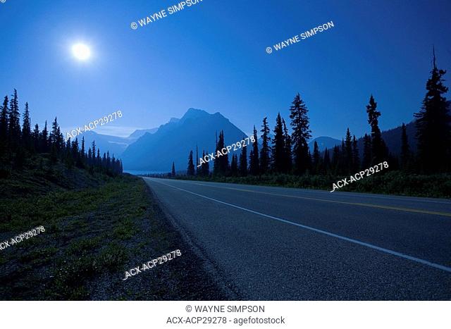 A full moon lights the Icefields Parkway as it leads to Crowfoot Mountain and Bow Lake in Banff National Park in the Canadian Rocky Mountains