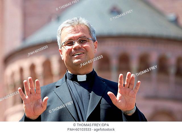 The new Auxiliary Bishop in the diocese of Mainz, Udo Bentz, stands in front of a church at a press conference for his introduction in Mainz, Germany