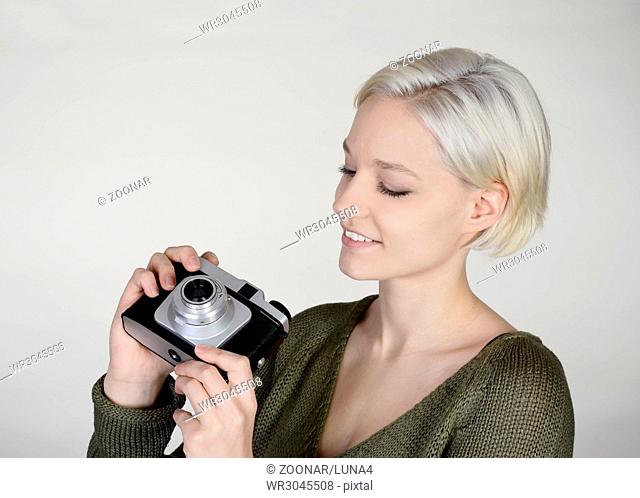 young woman with old camera