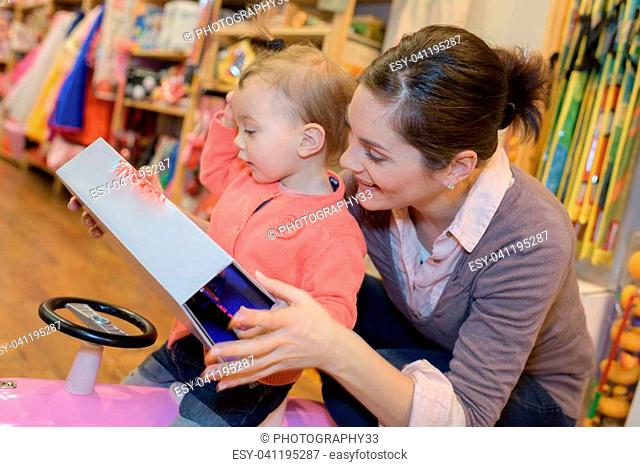 mother and daughter shopping for toys